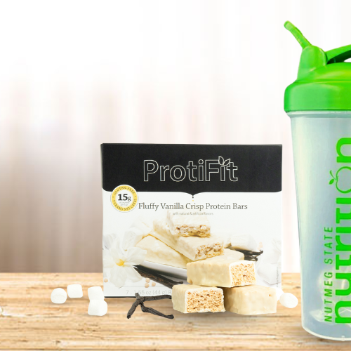 Assortment of Proti Foods weight loss gifts with a Christmas tree in the background.